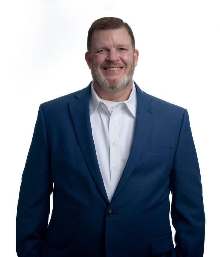 Mike Webb, owner of Webb Insurance Group, in a navy suit